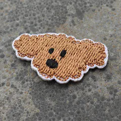 Het geborduurde embleem Hondje Blond