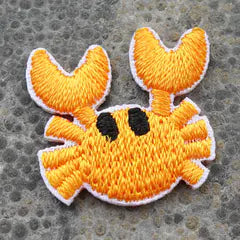 Het geborduurde embleem Krabbetje